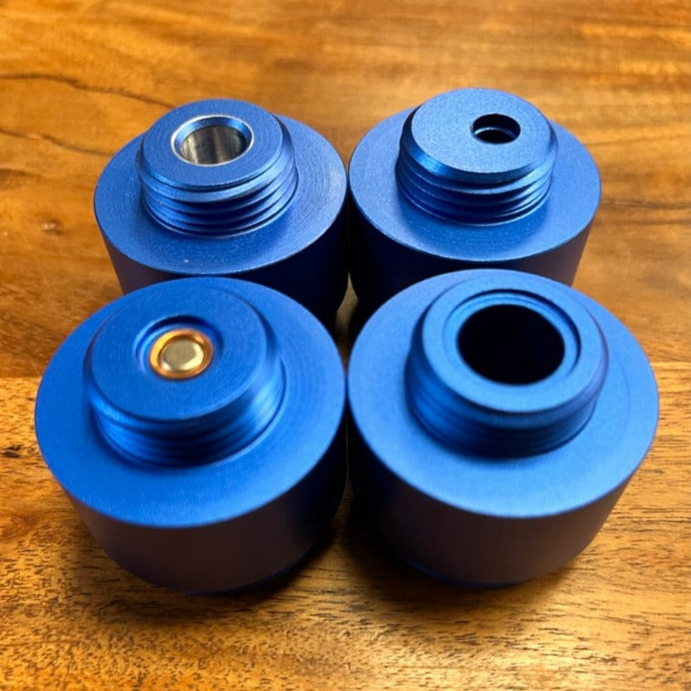 a group of four blue rollers sitting on top of a wooden table