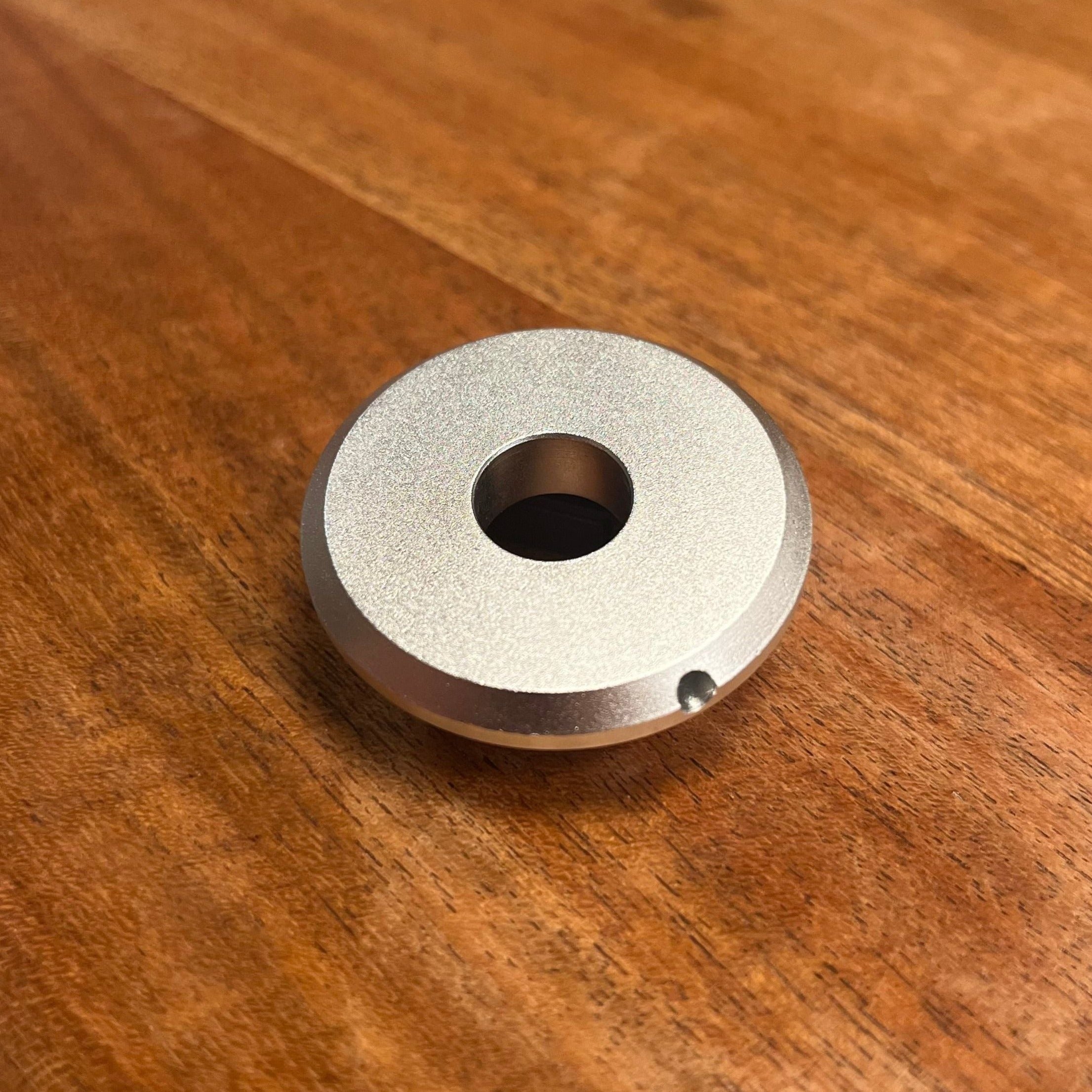 a metal object sitting on top of a wooden table